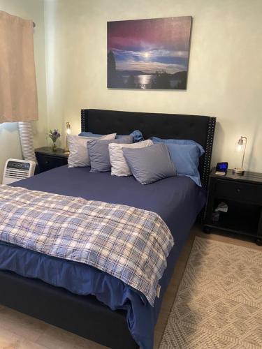 a bedroom with a bed with blue and white pillows at Lake Room in Sandpoint