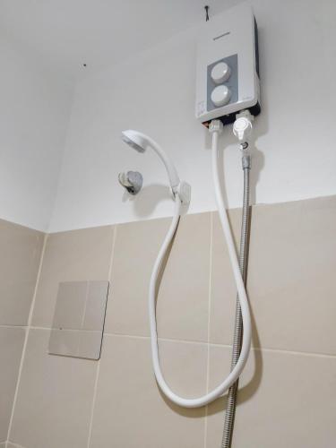 a shower in a bathroom with a shower head at DASIG Homes1 near airport, Bayanihan Flats 1 Condominium Mactan in Pajak
