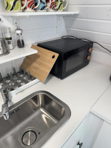 a kitchen with a sink and a microwave at Han's Solo 75 in Athenry