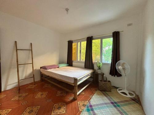 a bedroom with a bed in a room with a window at Beachside House with 2 bedrooms in Dalumpinas Oeste