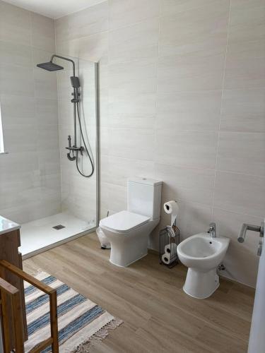 a bathroom with a shower and a toilet and a sink at Casa Brumar Beach and Downtown on Foot in Praia da Vitória
