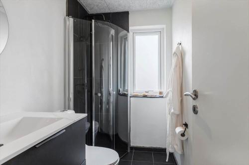 a bathroom with a shower and a toilet and a sink at G213-Lemvig-Skovstjernevej-13 in Lemvig