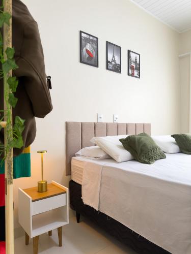 a bedroom with two beds and a side table at Casa 01 - Completa e moderna 5 minutos do centro in Alta Floresta