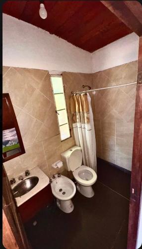 a bathroom with a sink and a toilet and a sink at Cabaña Camping Cabalango in Cavalango