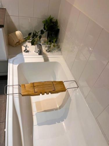 a bathroom with a white tub with a sink at Seaside Escape Rockingham in Rockingham