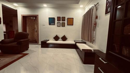 a living room with a couch and a chair at Nasik Homestay in Nashik