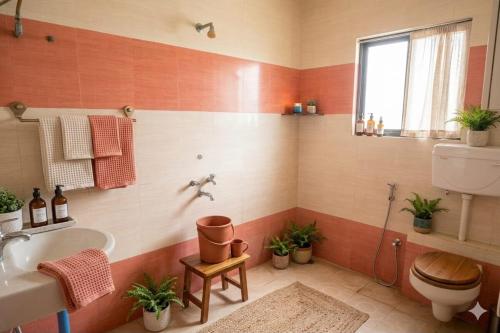 a bathroom with a toilet and a sink at Nasik Homestay in Nashik