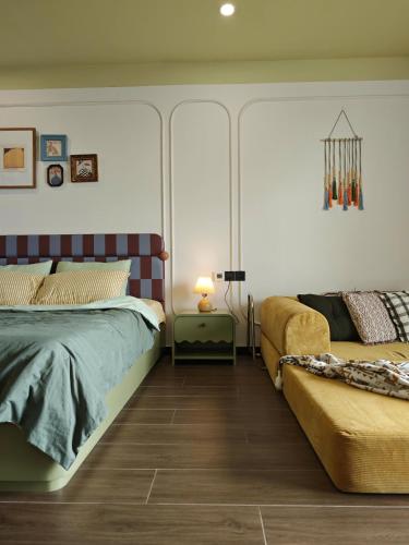 a bedroom with a bed and a couch at Homestay- Phòng nghỉ Lazur Cửa Lò in Giáp Vinh Yên