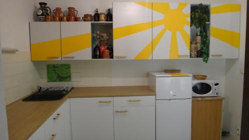 a kitchen with white cabinets and a white refrigerator at Prázdninový dům - PACL Červená Řečice in Červená Řečice