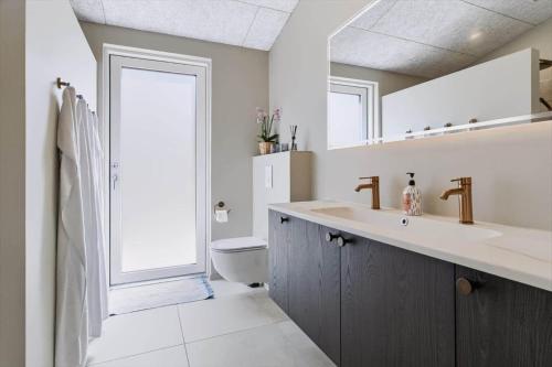 a bathroom with a sink and a toilet at 839-Harboore-Strandvaenget-6 in Harboør