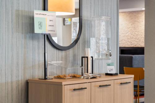 a table with a mirror on top of it at Garner Hotel Wadsworth by IHG in Wadsworth