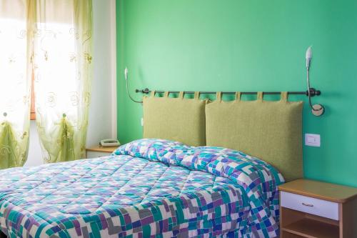 Кровать или кровати в номере Albergo Colonna