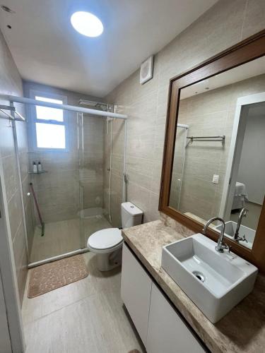 a bathroom with a sink and a shower and a toilet at Canoa Breeze - Beach Front in Canoa Quebrada