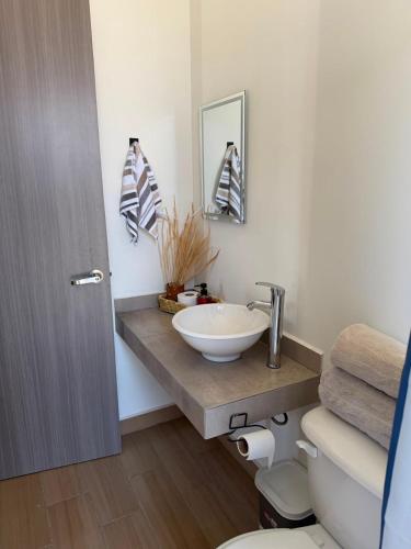 a bathroom with a sink and a toilet at Casa Zaabi in Oaxaca City