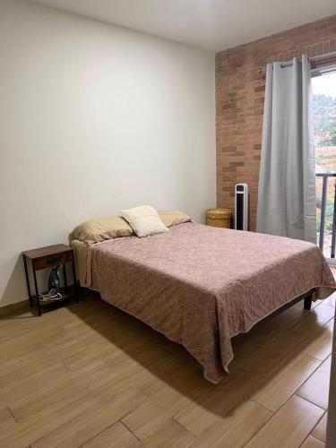 a bedroom with a large bed and a window at Casa Zaabi in Oaxaca City