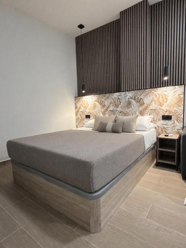 a bedroom with a large bed and a table at Apartamentos Nuevos en Valencia in Valencia