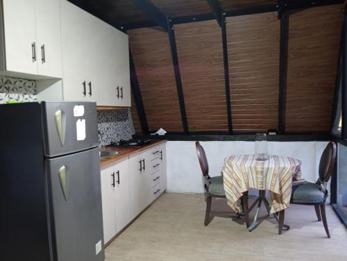 a kitchen with a table and a refrigerator at Casa paula in San Agustín