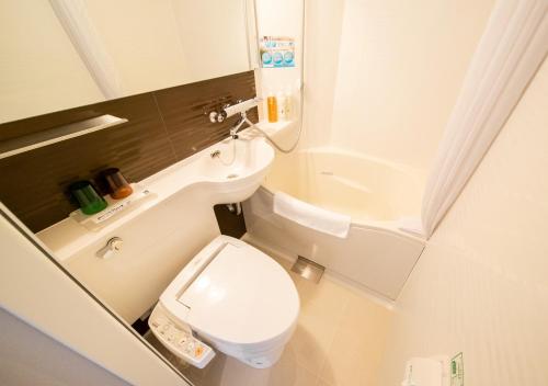 a small bathroom with a toilet and a sink at Super Hotel Totsuka Eki Higashiguchi in Yokohama