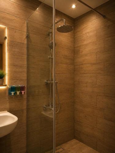a shower with a glass door in a bathroom at La Hacienda Ras Sedr in Ras Matarma