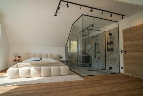 a bedroom with a bed and a glass shower at Das Freyenstein in Berghof
