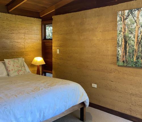 a bedroom with a bed and a window at Eucalyptus House in Pemberton