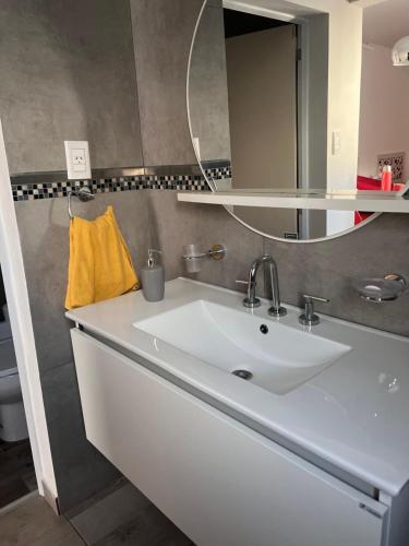 a bathroom with a white sink and a mirror at Temporario Martínez in General Pico