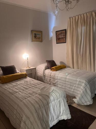 a bedroom with two beds and a window at Temporario Martínez in General Pico