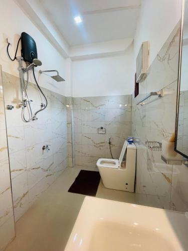a white bathroom with a toilet and a shower at Ella Hillcrest Heaven-Free Pickup from Ella in Ella