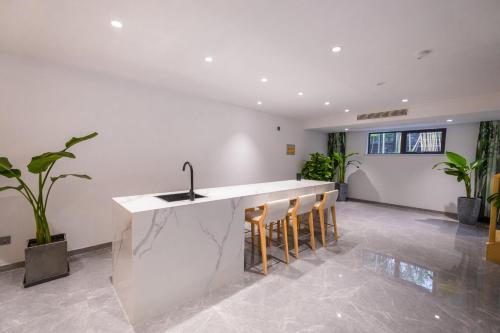 a kitchen with a sink and some plants at HuzhouGiraffe ManorHotel in Huzhou
