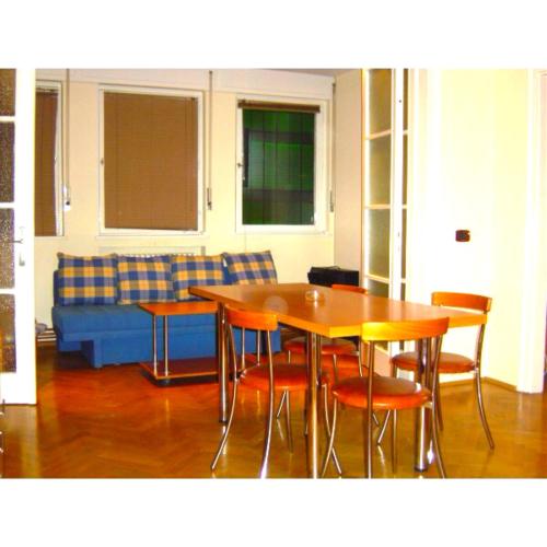 ein Wohnzimmer mit einem Tisch, Stühlen und einem Sofa in der Unterkunft Sepcari Old City Apartment in Bukarest