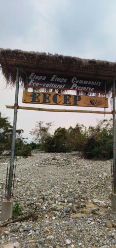 a sign for a bar on a rocky beach at Eya Nest Homestay in Mekha