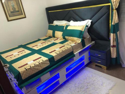 a bedroom with a bed with blue drawers at AFRAAH GUEST House 2 in Yaoundé