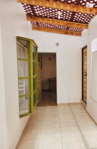 a hallway of a house with a green door at Alojamiento casa en Toconao, chile in Toconao