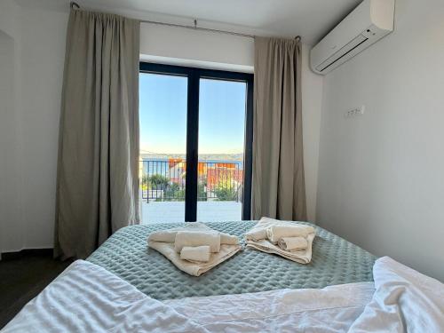 a bedroom with a bed with two towels on it at Casa Bol Old Town in Bol