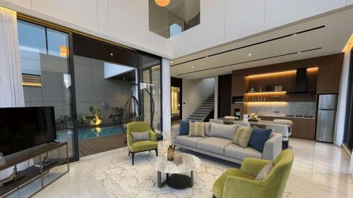 a living room with a couch and a tv at Alcola Boutique Villa - Caspia Unit in Tlekung