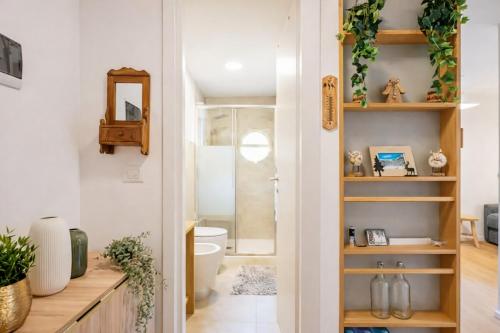 a bathroom with a toilet and a sink at Suite Bormio - with WIFI & Netflix in Piatta