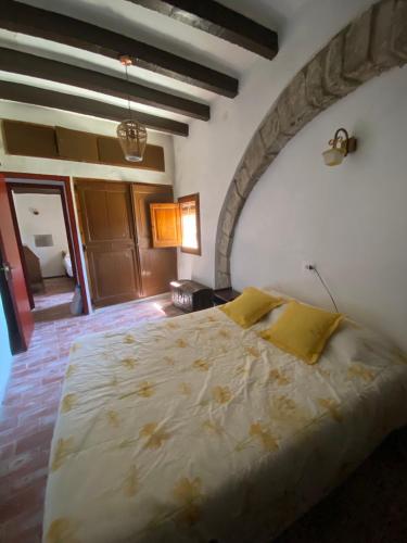 a bedroom with a large bed in a room at Cal Rabell in Bellmunt