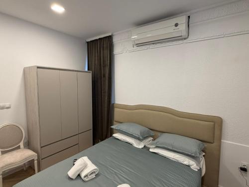 a bedroom with a bed and a air conditioner at Tempo apartments in Pazardzhik