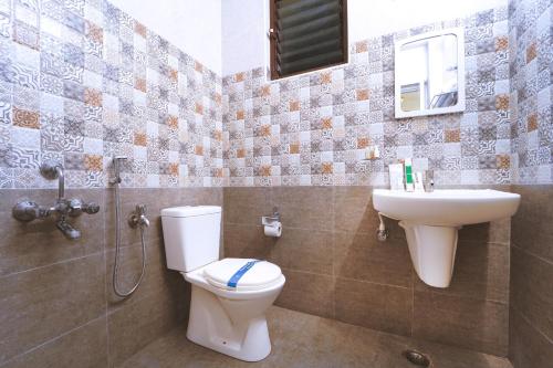 a bathroom with a toilet and a sink at YAFA Palace in Rāmanāthapuram