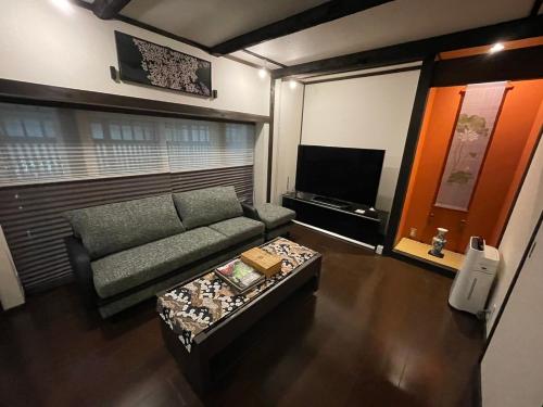 a living room with a couch and a coffee table at Rinn Kiyomizu Villa in Kyoto