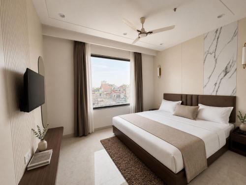a bedroom with a large bed and a window at Hotel RajKailash in Jaipur