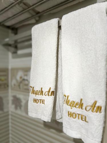 two towels with the words harakhar hotel on them at Thach An Hotel in Ðông Khê