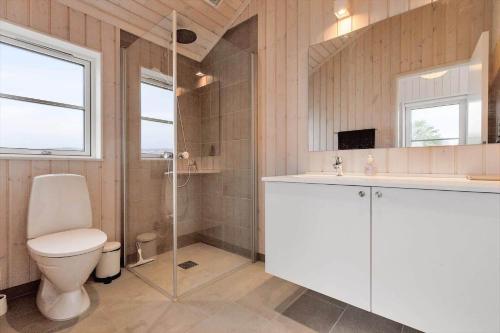 a bathroom with a toilet and a shower and a sink at 16666-Farevejle-Karuphoj-4-E in Fårevejle