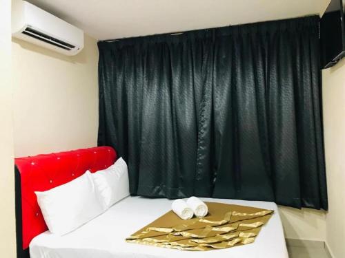 a room with a bed with a red head board at Georgetown New Wave Hotel in George Town