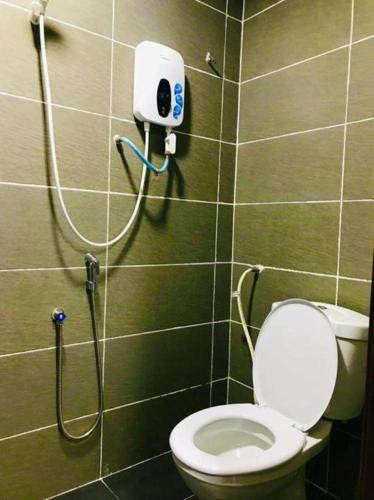 a bathroom with a toilet and a shower at Georgetown New Wave Hotel in George Town