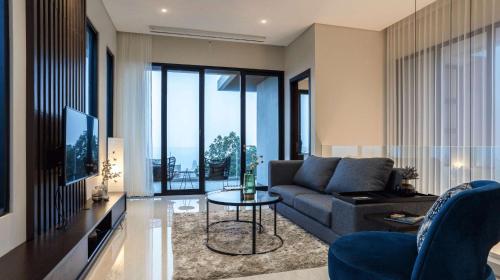 a living room with a couch and a table at Alcola Boutique Villa - Astonia Unit in Batu