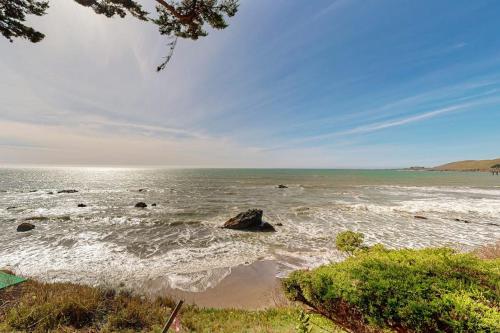 a large body of water with rocks in it at Oceanfront Delight in Cayucos