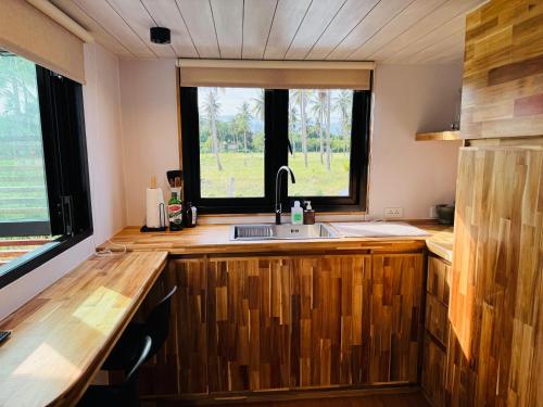 a kitchen with a sink and a window at Private Sunset Beachfront Thainee Villa in Nathon Bay