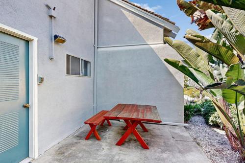 a red picnic table sitting next to a building at Sugar Shack in Carpinteria