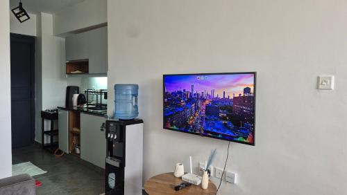 a flat screen tv hanging on a wall at Hise Haven Stays in Kiambu